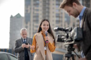 young-cute-female-reporter-talking-to-a-videocamer-2024-10-17-04-38-12-utc